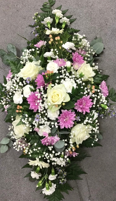 Fresh flower sympathy tribute in pink and white seasonal flowers and foliage