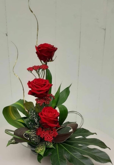 Fresh red rose arrangement and selection of foliages