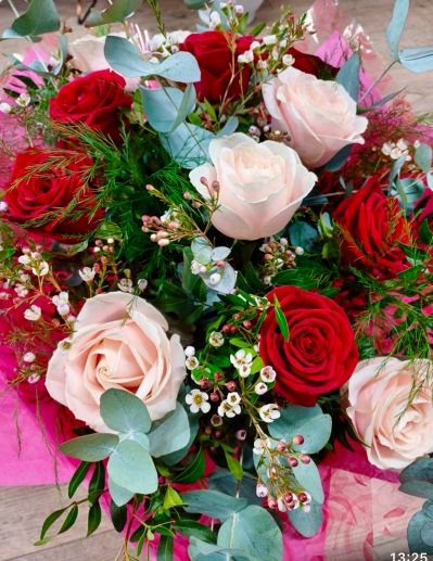 Large bouquet of red and pink roses and selection of foliages