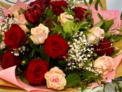 12 mixed red and pink roses, created in a hand tied style and delivered in a bubble of water in our delivery box