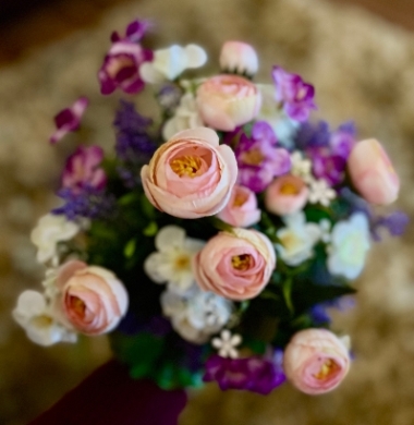 A med size faux flower wedding bouquet , with mauve shades and a selection of faux foliage