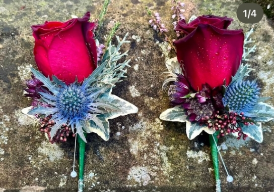 A selection of buttonholes with red rose and thistle and foliage retail