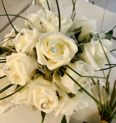 Wedding bouquet of white foam flowers and diamanté pins in the rose and enhanced with grasses